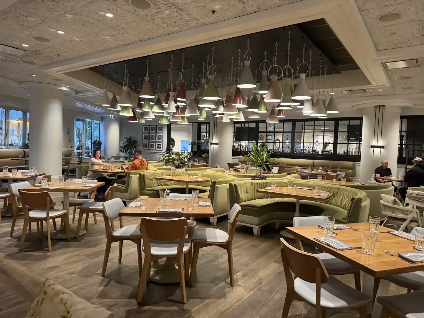 Contemporary hotel interior with layered lighting and open lounge seating